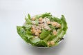 Top view of bowl of caesar salad with lettuce, bacon and croutons on white table. Royalty Free Stock Photo