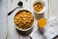 Top view of a bowl of cereal corn flakes and fruit juice Royalty Free Stock Photo