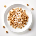 Top view of bowl of cereals with milk.