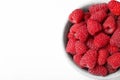 Top view of bowl with delicious ripe raspberries on white background, Royalty Free Stock Photo