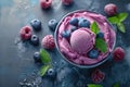 top view bowl with delicious summer treat ice cream balls with blueberries, raspberries and mint leaves on gray concrete Royalty Free Stock Photo