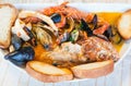 Top view of bowl with fish soup with seafood