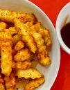 Top view of a bowl of fried potatoes with a sauce on the table Royalty Free Stock Photo