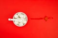 Top view of a bowl of glutinous rice balls with a spoon isolated on a red background