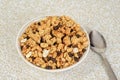 Top view bowl of granola raisin almond cereal with a spoon Royalty Free Stock Photo