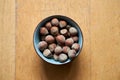 Top view of a bowl of hazelnuts on a wooden table in a blurred background Royalty Free Stock Photo