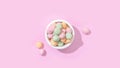 Top view of a bowl of jelly candies with different flavours isolated on a pastel pink background