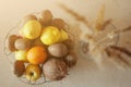 Top view of bowl of many fruits on the table with rustic straw plants in vase