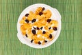 Top view of  bowl of milk with cereals with dried fruits on a green background Royalty Free Stock Photo