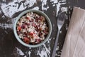 Top view of bowl with salad from tomato, cooked beans and mixed brown and black rice on the wooden background Royalty Free Stock Photo