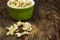 top view of bowl of Tasty cashew nuts on wood table.