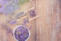 Top view of a bowl and wooden spoons with fresh lavender flowers, lavender essential oil and a bouquet of lavender Royalty Free Stock Photo