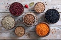 top view bowls with assorted beans and lentils on wooden background