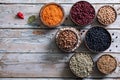 top view bowls with assorted beans and lentils on wooden background