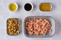 Top view of bowls with shrimps, mussels, sauces and garlic oil