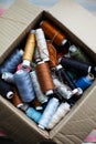 Top view of a box with skeins of colored thread. white table. workplace tailor. sewing industry Royalty Free Stock Photo