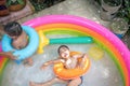 Top view of boy play water in kiddie pool. Leisure activity
