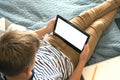 Top view on boy writing or drawing and using his tablet while doing homework. Studying online during quarantine, online training Royalty Free Stock Photo