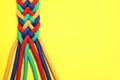 Top view of braided colorful ropes on yellow background, space for text Royalty Free Stock Photo