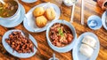 Top view of braised pork leg and dried mushroom slice fried and steamed bun on a plate on a wooden table Royalty Free Stock Photo