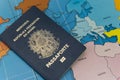 Top view of Brazilian passport over map. Focus on the European and African continent. Emigration, travel, destination concept.