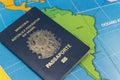 Top view of Brazilian passport over map. Focus on the South American continent. Emigration, travel, destination concept