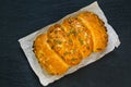 Top view of bread loaf with pumpkin seeds on black slate stone board Royalty Free Stock Photo