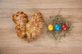 Top view of bread next to colorful eggs for Easter decoration