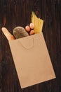 Top view of bread, pasta and eggs in shopping bag on wooden table Royalty Free Stock Photo