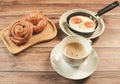 Top view of break fast set ,, cup of coffee fried eggs , danish pastry and Croissant on wooden background Royalty Free Stock Photo