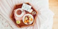 Top view Breakfast in bed with Have a nice day text on lighted box. Cup of coffee, juice, macaroons on wooden tray. Good morning Royalty Free Stock Photo
