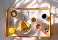 Top view of breakfast in bed on tray at sunny morning at home for mom on Mother`s Day Royalty Free Stock Photo