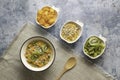 Top view of breakfast with bowls of oatmeal and fruits