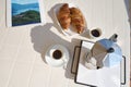 Top view: breakfast in Italian style. Two cups of espresso coffee, freshly baked croissants and percolator on the table Royalty Free Stock Photo