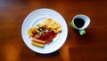 Top view of breakfast with omelet, bacon, many sausage, fried vegetable and tomato or chili sauce with green cup of black coffee. Royalty Free Stock Photo