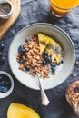 Top view of breakfast table for one, crunchy granola with fresh berries and cream or milk. Royalty Free Stock Photo