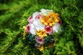 Top view of bridal bouquet with white, yellow and rose flowers on grass in summer wedding day. Outdoor wedding decor. Idea for Royalty Free Stock Photo