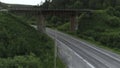 Top view of bridge with road under it in forest. Scene. Old bridge over rural highway in wooded area. Bridge with roads Royalty Free Stock Photo