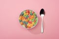 Top view of bright colorful breakfast cereal in bowl near spoon Royalty Free Stock Photo