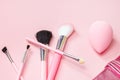 Top view of bright pink decorative cosmetics tools and accessories for professional make up and visage on light background Royalty Free Stock Photo