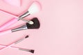 Top view of bright pink decorative cosmetics tools and accessories for professional make up and visage on light background Royalty Free Stock Photo