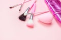 Top view of bright pink decorative cosmetics tools and accessories for professional make up and visage on light background Royalty Free Stock Photo