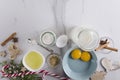 Top view of broken eggs, bottle of milk, sugar, aromatic spices and Christmas ornaments on the marble white table.Empty space for Royalty Free Stock Photo