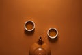 Top view of brown ceramic chinese teapot and cups of tea