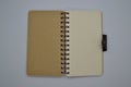 Top view of brown and cream-colored notebook recycled paper on a white background with a blank page Royalty Free Stock Photo