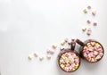 Top view of brown cups of hot cocoa with marshmallows in heart shape on white background Royalty Free Stock Photo