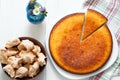 Top view: brown meringues and manna semolina pie on white wooden table