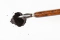 Top view of brown nib pen over black ink blot Royalty Free Stock Photo