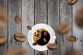 Top view of brown roasted coffee beans falling and flying to coffee cup.Represent breakfast for energy and freshness concept Royalty Free Stock Photo