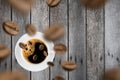 Top view of brown roasted coffee beans falling and flying to coffee cup. Royalty Free Stock Photo